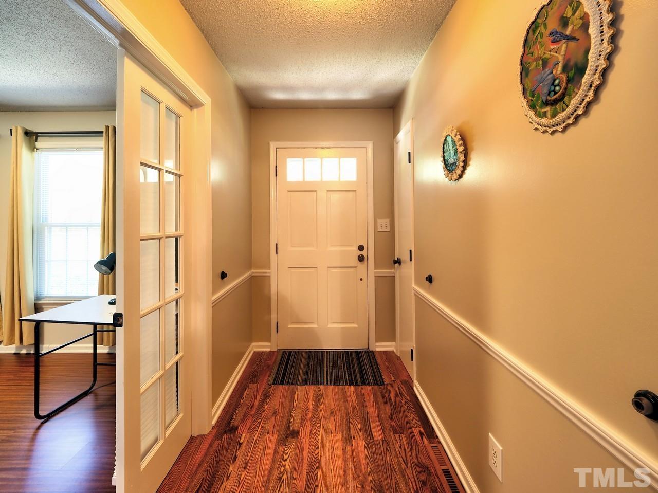 8329 Bells Lake Road Apex, NC 27539 - Photo 12 of 26 a view of a room with wooden floor and windows