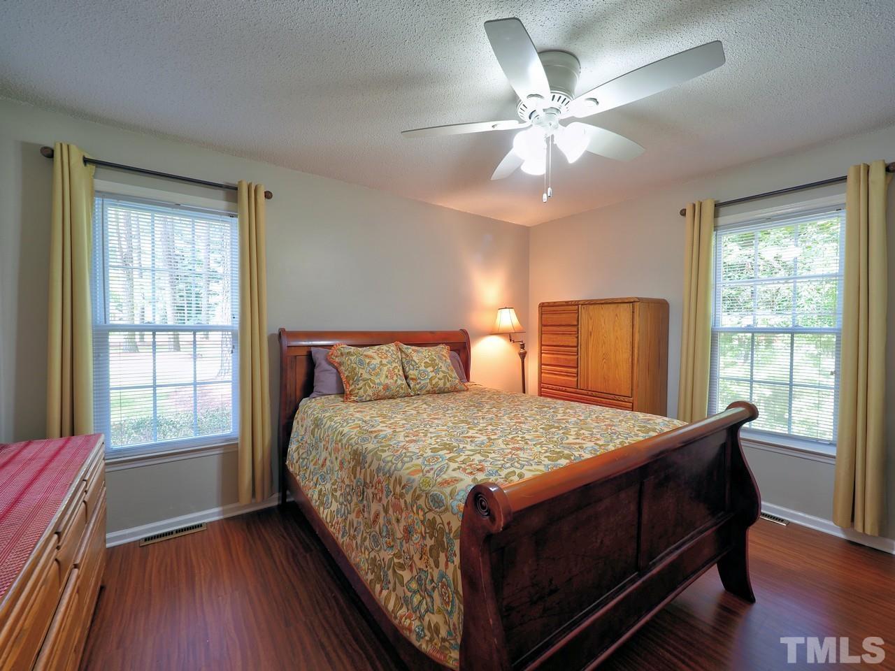 8329 Bells Lake Road Apex, NC 27539 - Photo 19 of 26 a bedroom with a large bed and a window