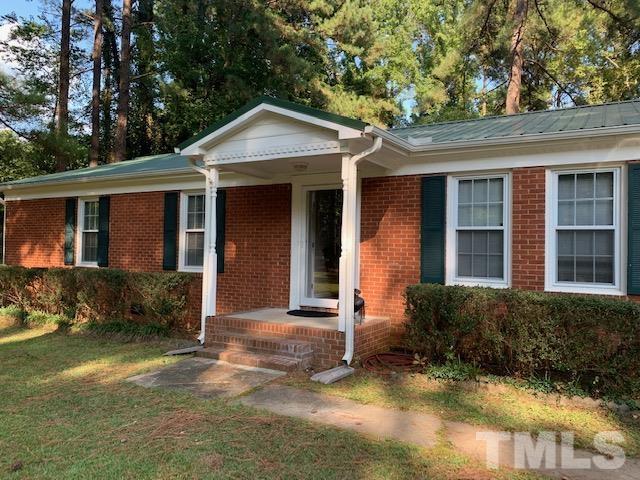 8329 Bells Lake Road Apex, NC 27539 - Photo 3 of 26 a front view of a house with garden