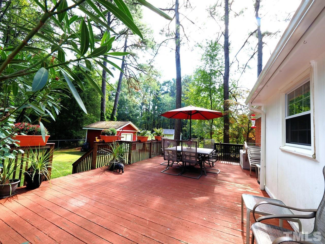 8329 Bells Lake Road Apex, NC 27539 - Photo 22 of 26 an outdoor space with furniture and umbrella
