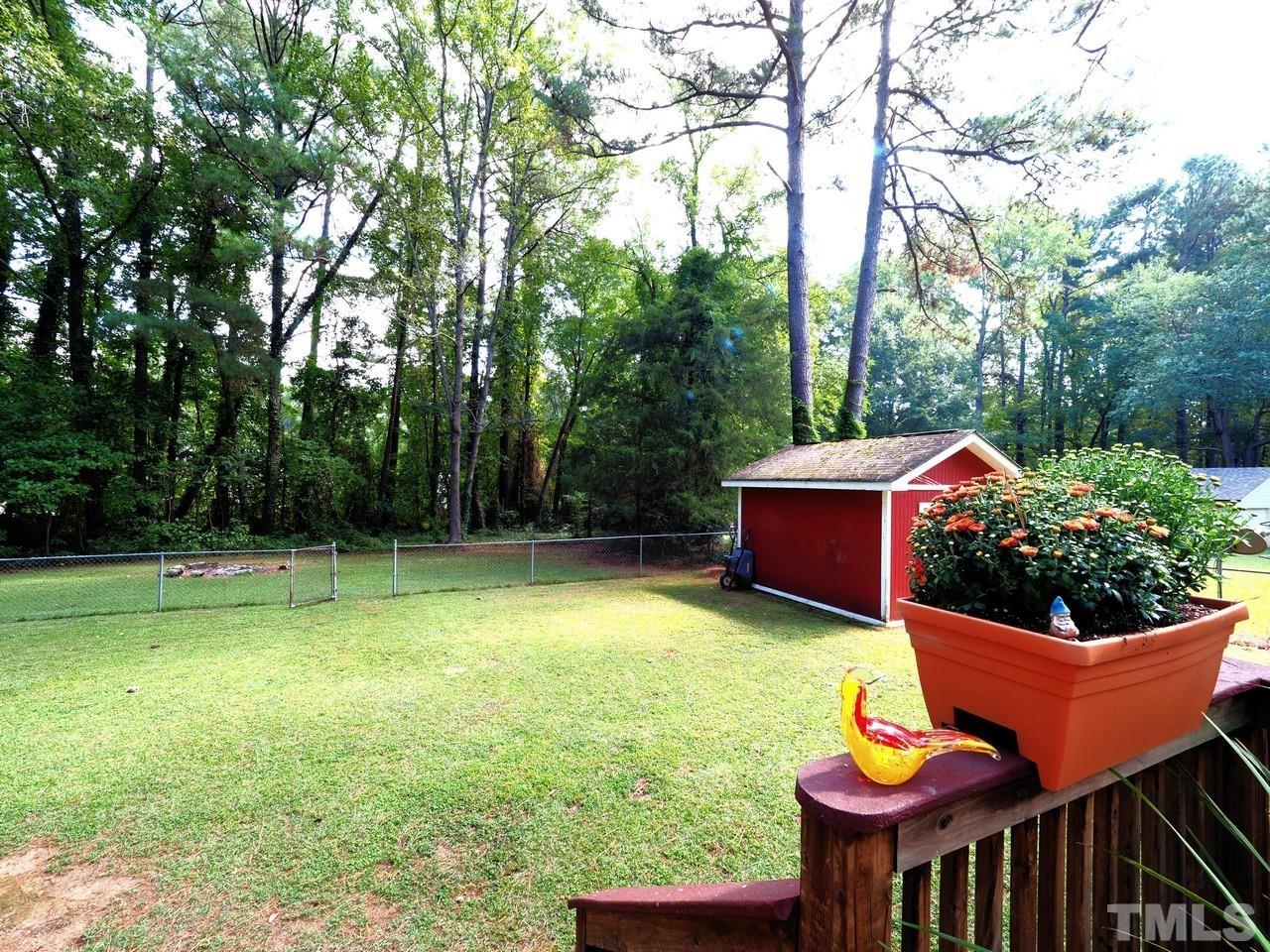 8329 Bells Lake Road Apex, NC 27539 - Photo 23 of 26 a backyard of a house with yard and trampoline