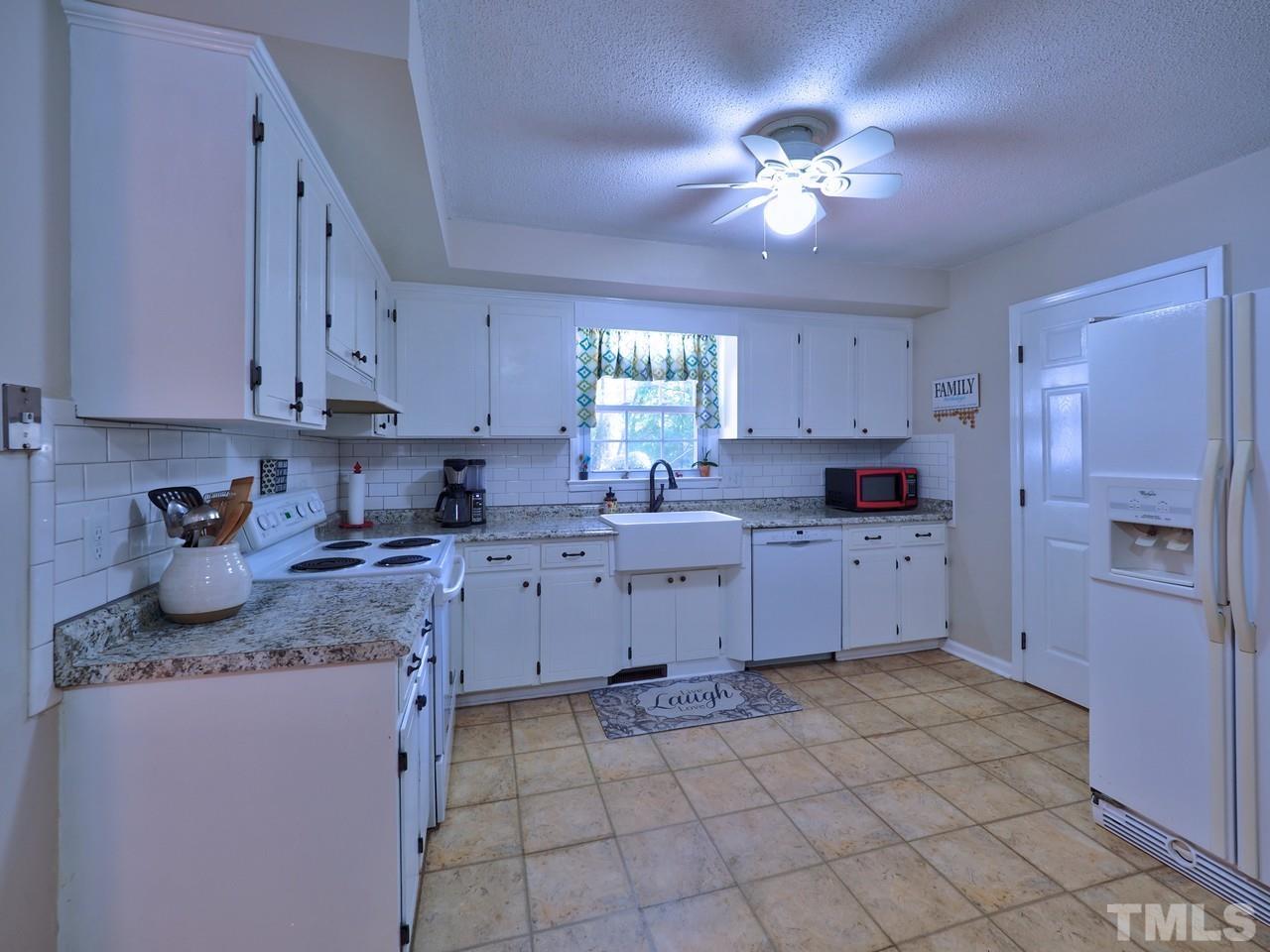 8329 Bells Lake Road Apex, NC 27539 - Photo 5 of 26 a kitchen with cabinets and window