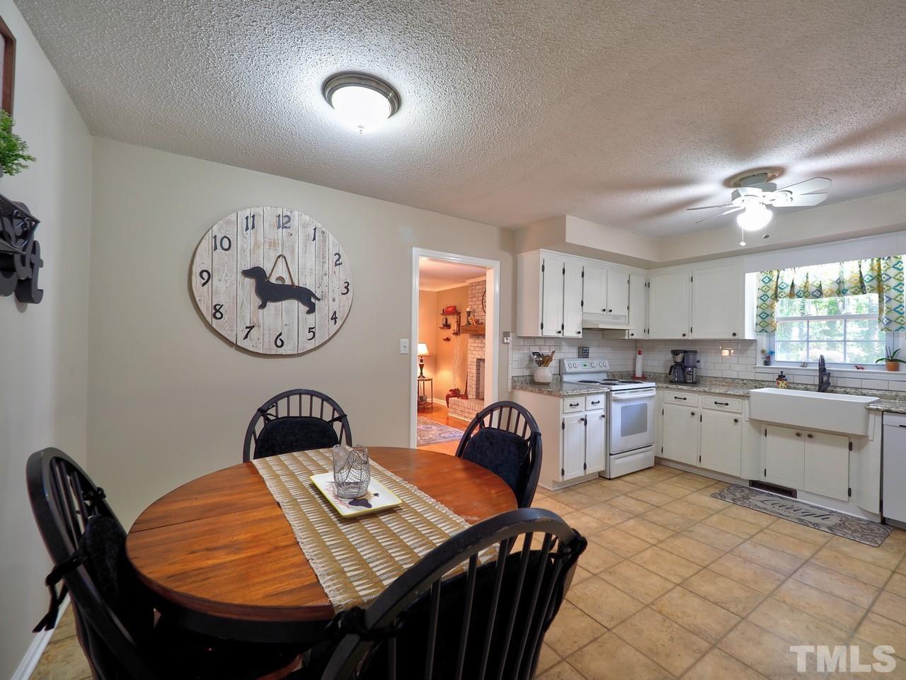 8329 Bells Lake Road Apex, NC 27539 - Photo 6 of 26 a view of a dining room with furniture window and wooden floor