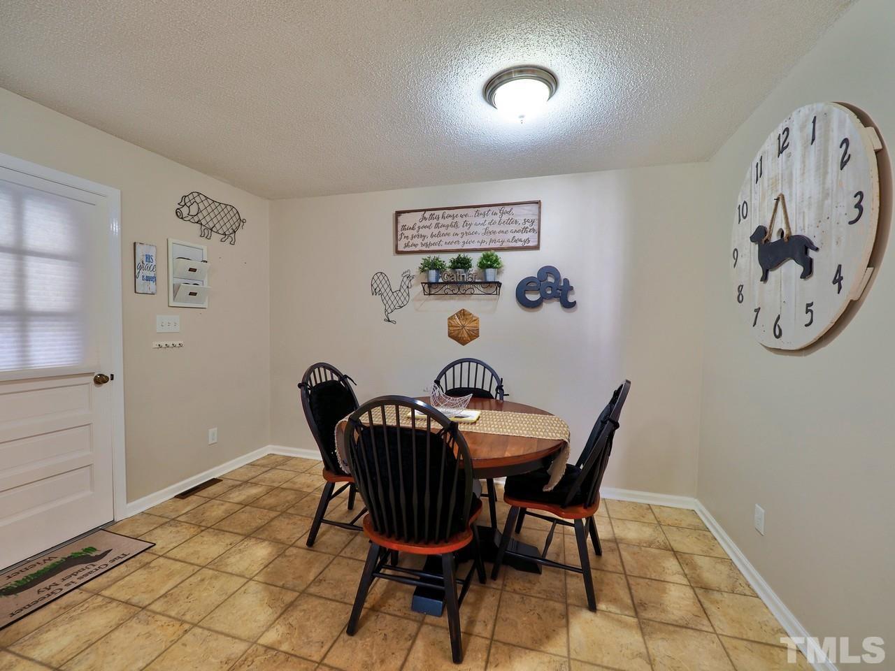 8329 Bells Lake Road Apex, NC 27539 - Photo 7 of 26 a view of a dining room with furniture