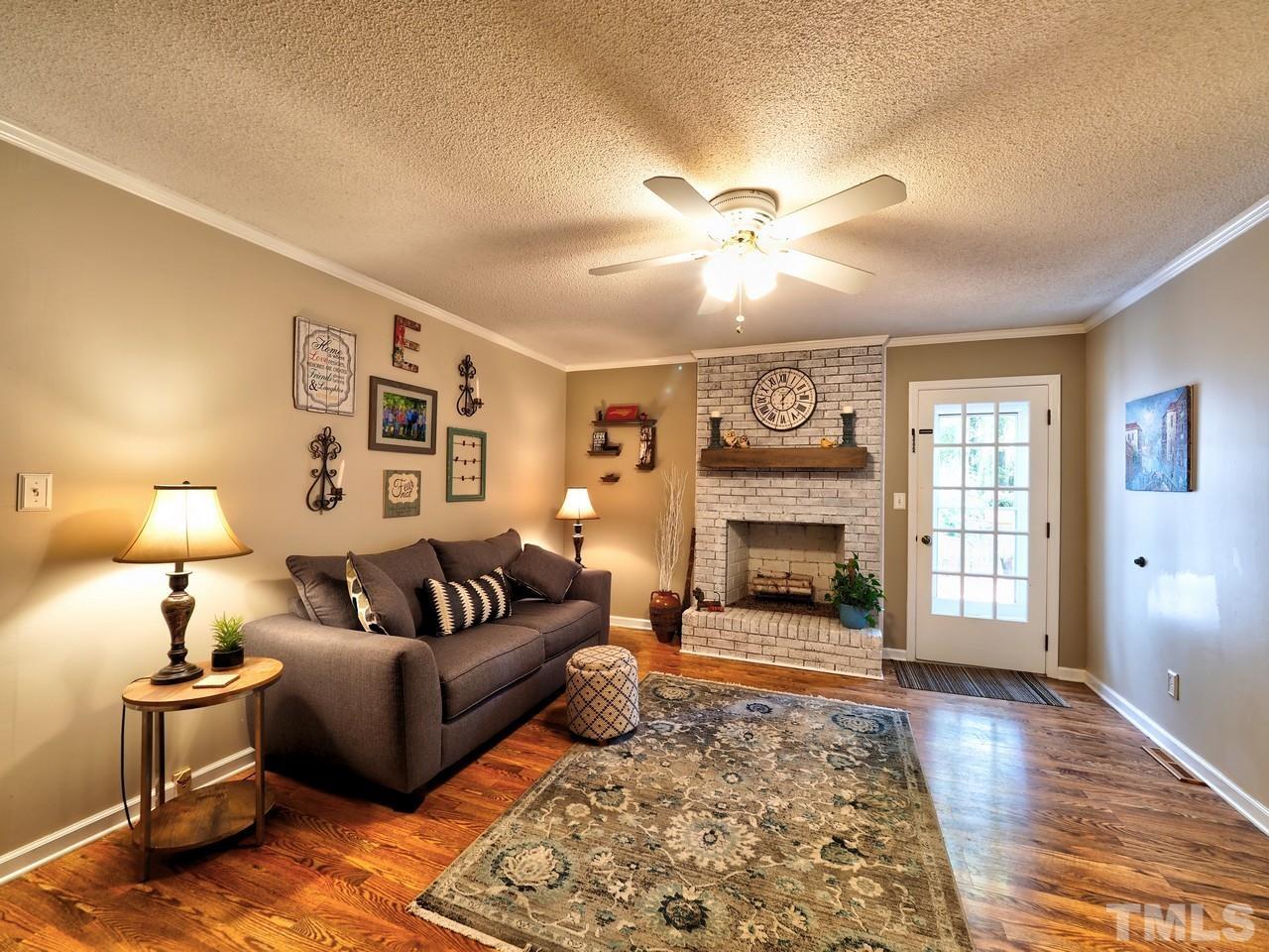 8329 Bells Lake Road Apex, NC 27539 - Photo 9 of 26 a living room with furniture and a fireplace