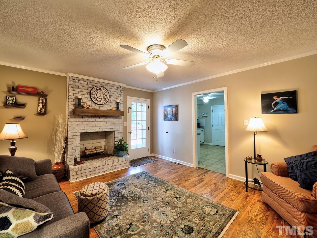 8329 Bells Lake Road Apex, NC 27539 - Photo 10 of 26 a living room with furniture and a fireplace