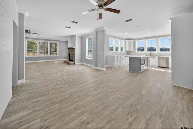a view of a livingroom with furniture and a kitchen