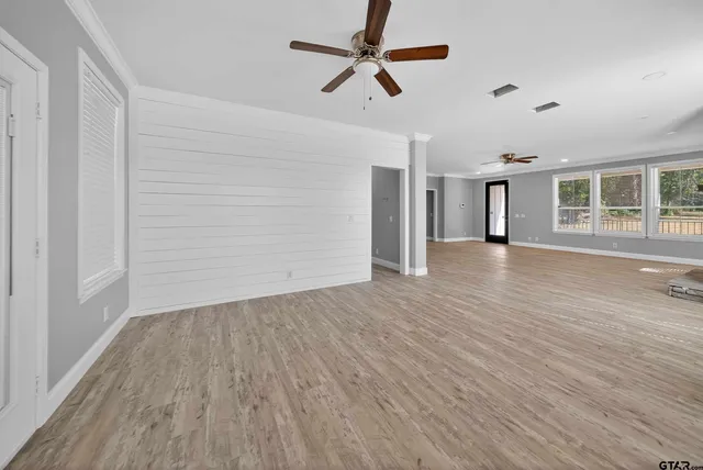 wooden floor in an empty room with a window