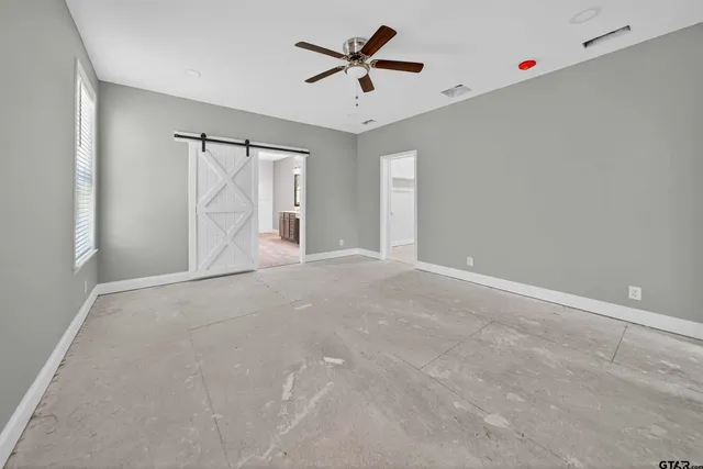 a view of a livingroom with a ceiling fan and window