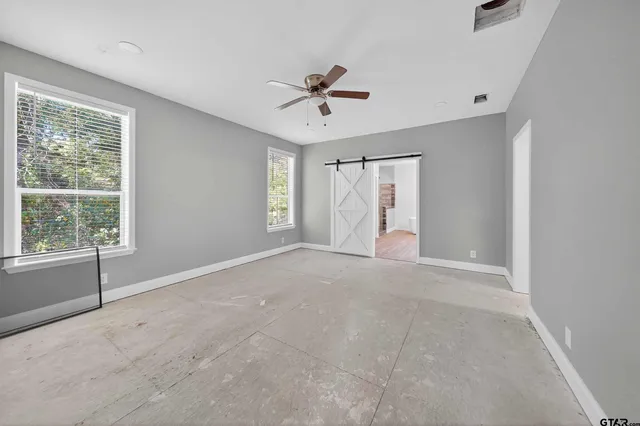 a view of a livingroom with a ceiling fan and window