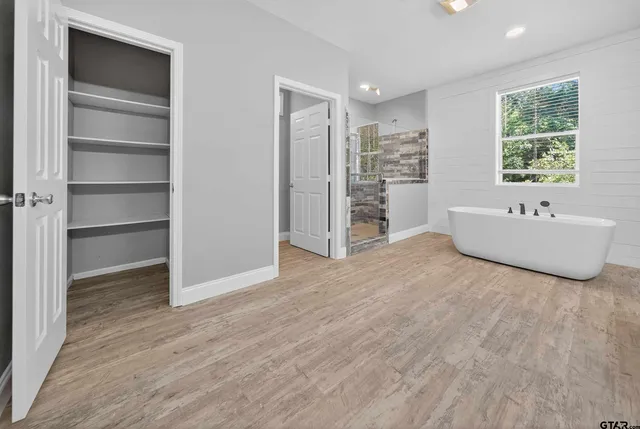 a spacious bedroom with a bed and a window