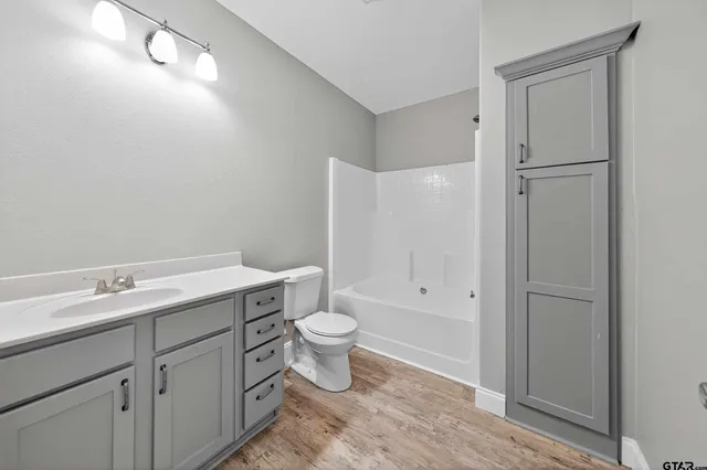 a bathroom with a toilet sink and shower