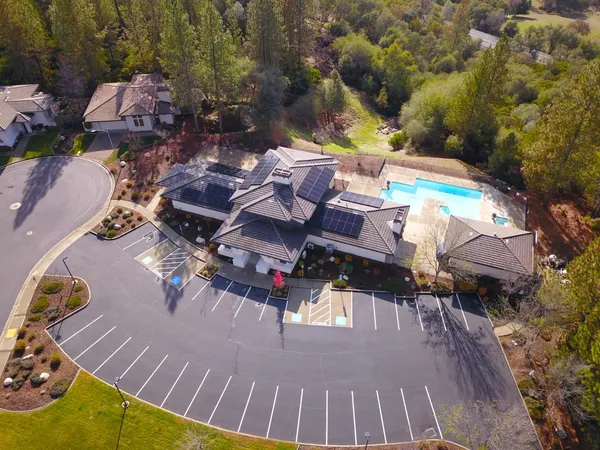 an aerial view of a house with swimming pool and patio