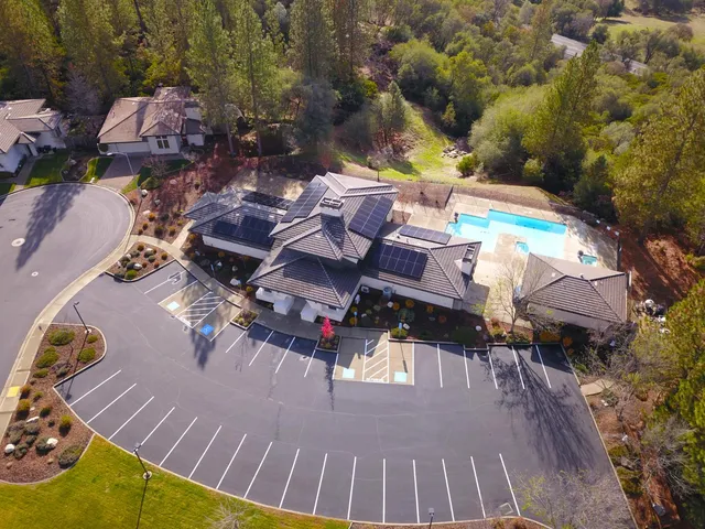 an aerial view of a house with swimming pool and patio