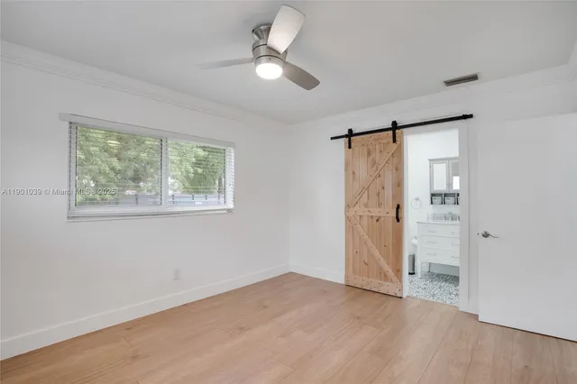 a bathroom with a granite countertop toilet sink and mirror