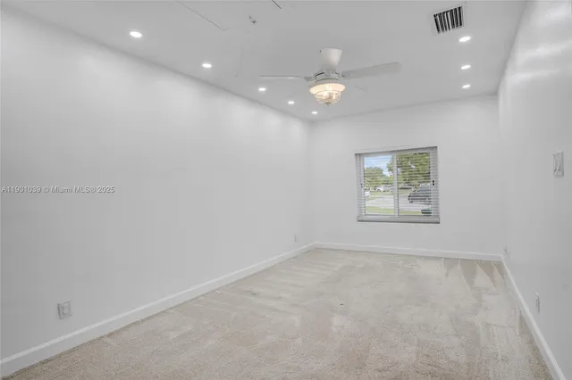 an empty room with closet and windows