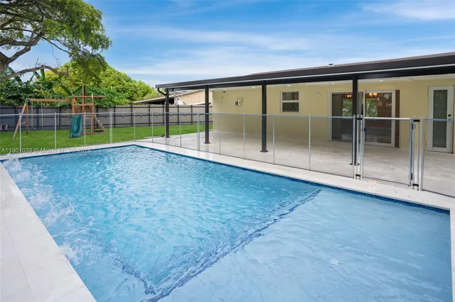 a view of backyard with seating area and green space