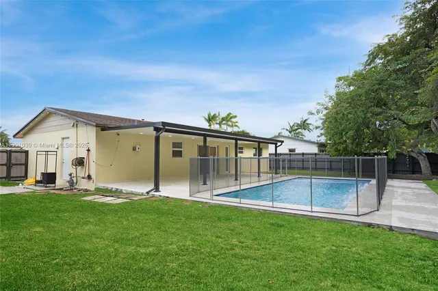 a view of a backyard with large trees