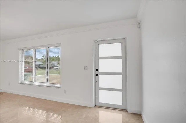 a large kitchen with kitchen island granite countertop a stove a sink a refrigerator and a window