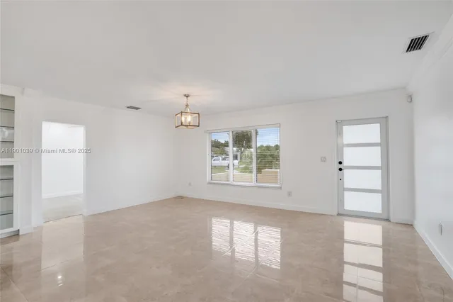 a view of an empty room with a window