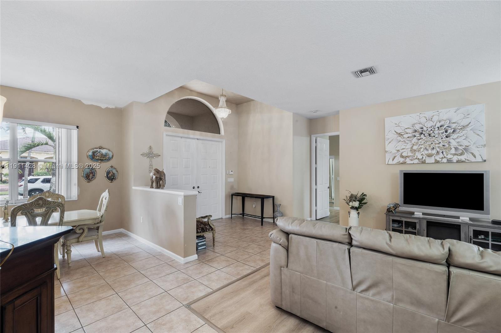 13875 Southwest 41st Street Davie, FL 33330 - Photo 12 of 62 a living room with furniture and a flat screen tv
