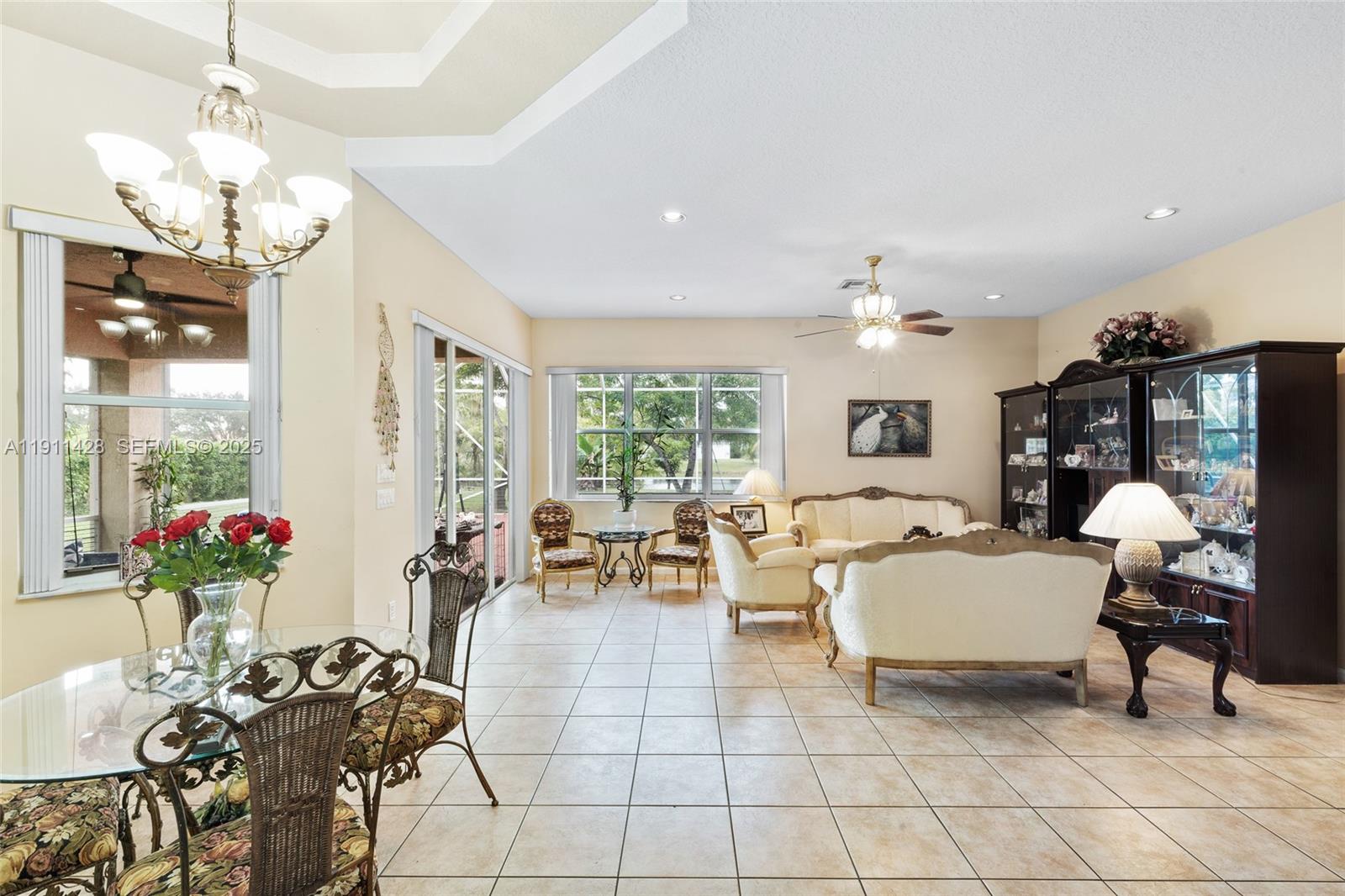 13875 Southwest 41st Street Davie, FL 33330 - Photo 18 of 62 a living room with furniture a chandelier and a chandelier