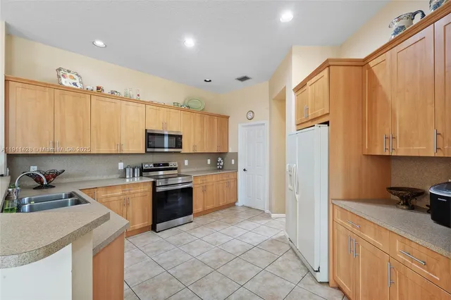 a kitchen with stainless steel appliances granite countertop a sink and cabinets