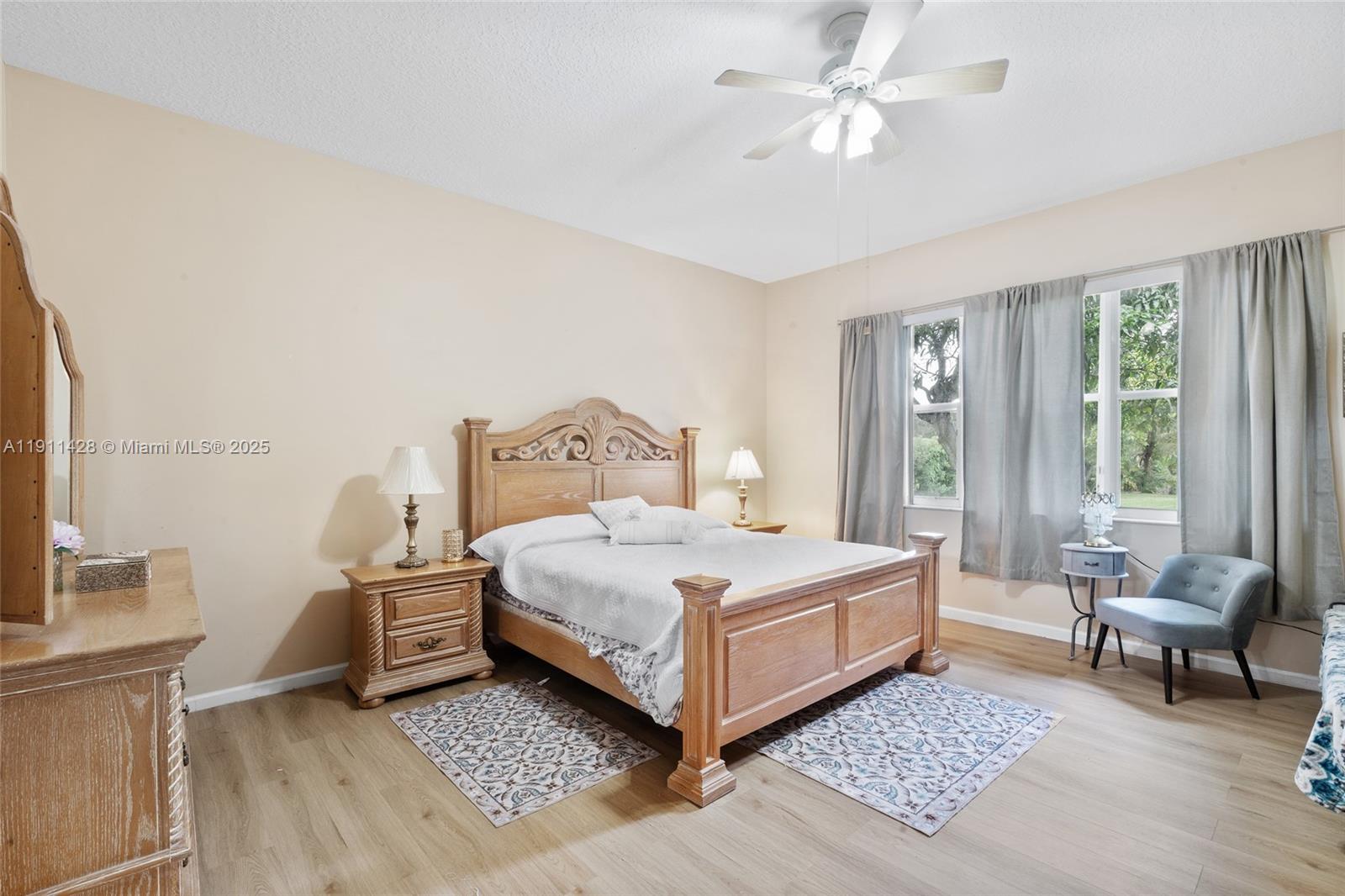 13875 Southwest 41st Street Davie, FL 33330 - Photo 24 of 62 a bedroom with a bed and a chandelier