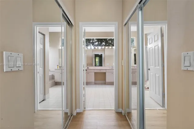 a spacious bathroom with a tub sink and mirror