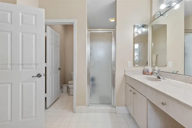 a bathroom with a sink mirror vanity and toilet