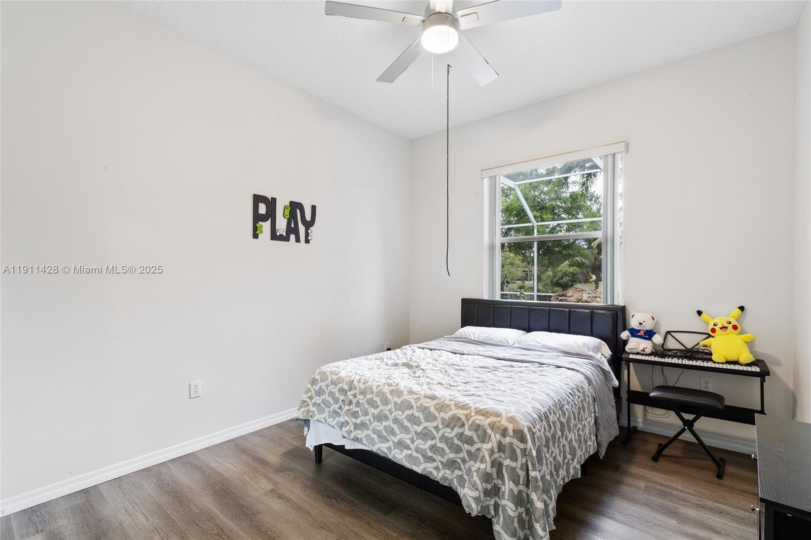 13875 Southwest 41st Street Davie, FL 33330 - Photo 32 of 62 a bedroom with a bed table and a window