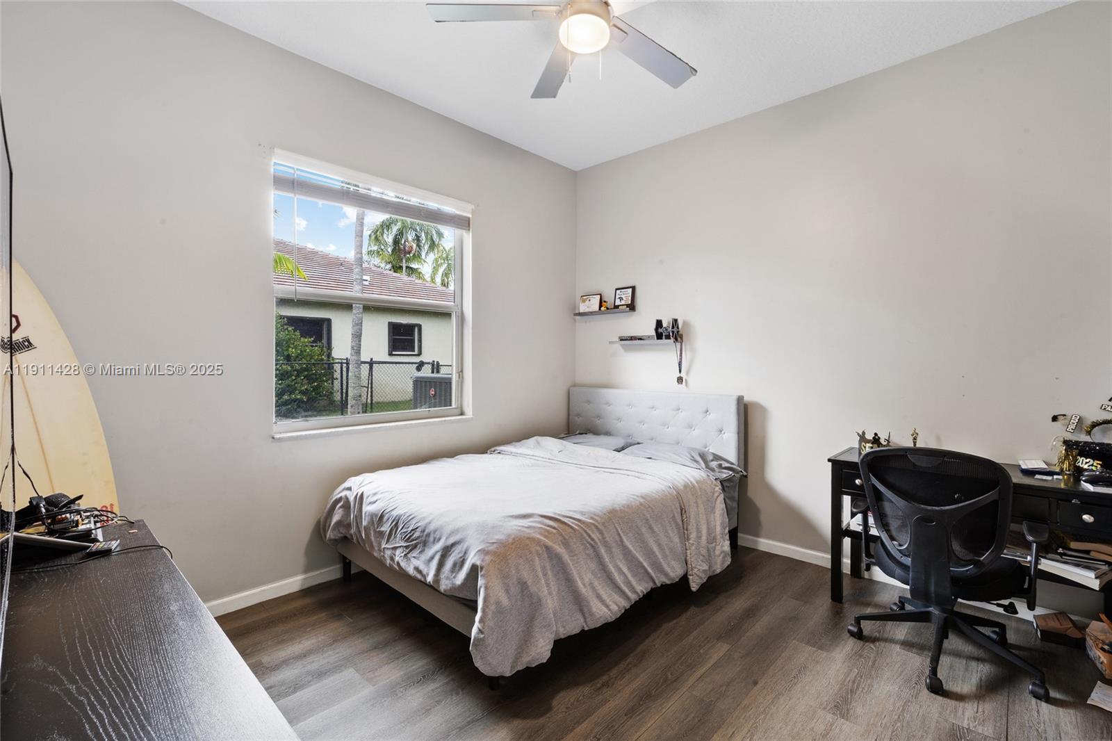 13875 Southwest 41st Street Davie, FL 33330 - Photo 33 of 62 a bedroom with a bed and a table in it