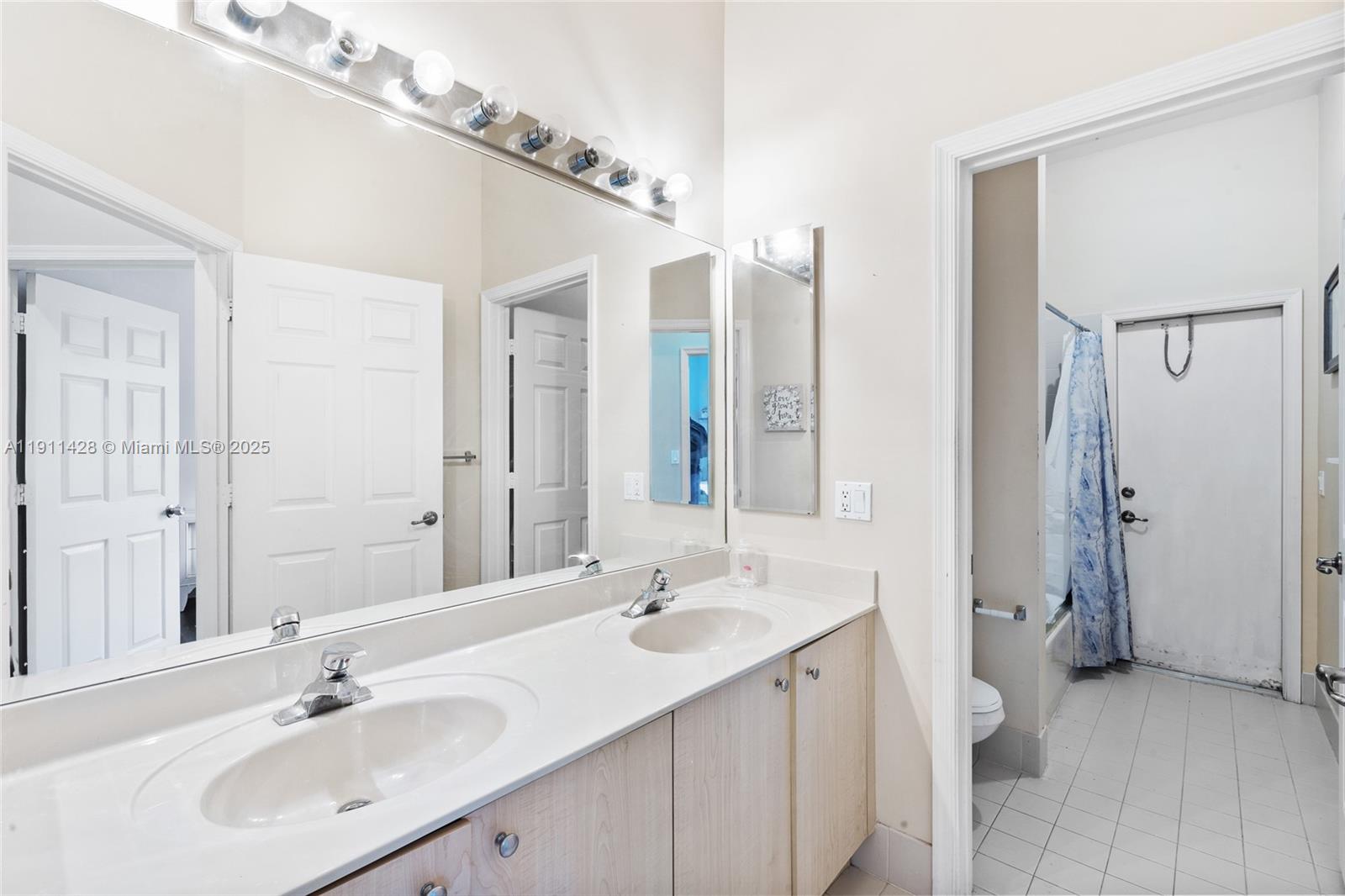 13875 Southwest 41st Street Davie, FL 33330 - Photo 35 of 62 a bathroom with a double vanity sink mirror and double