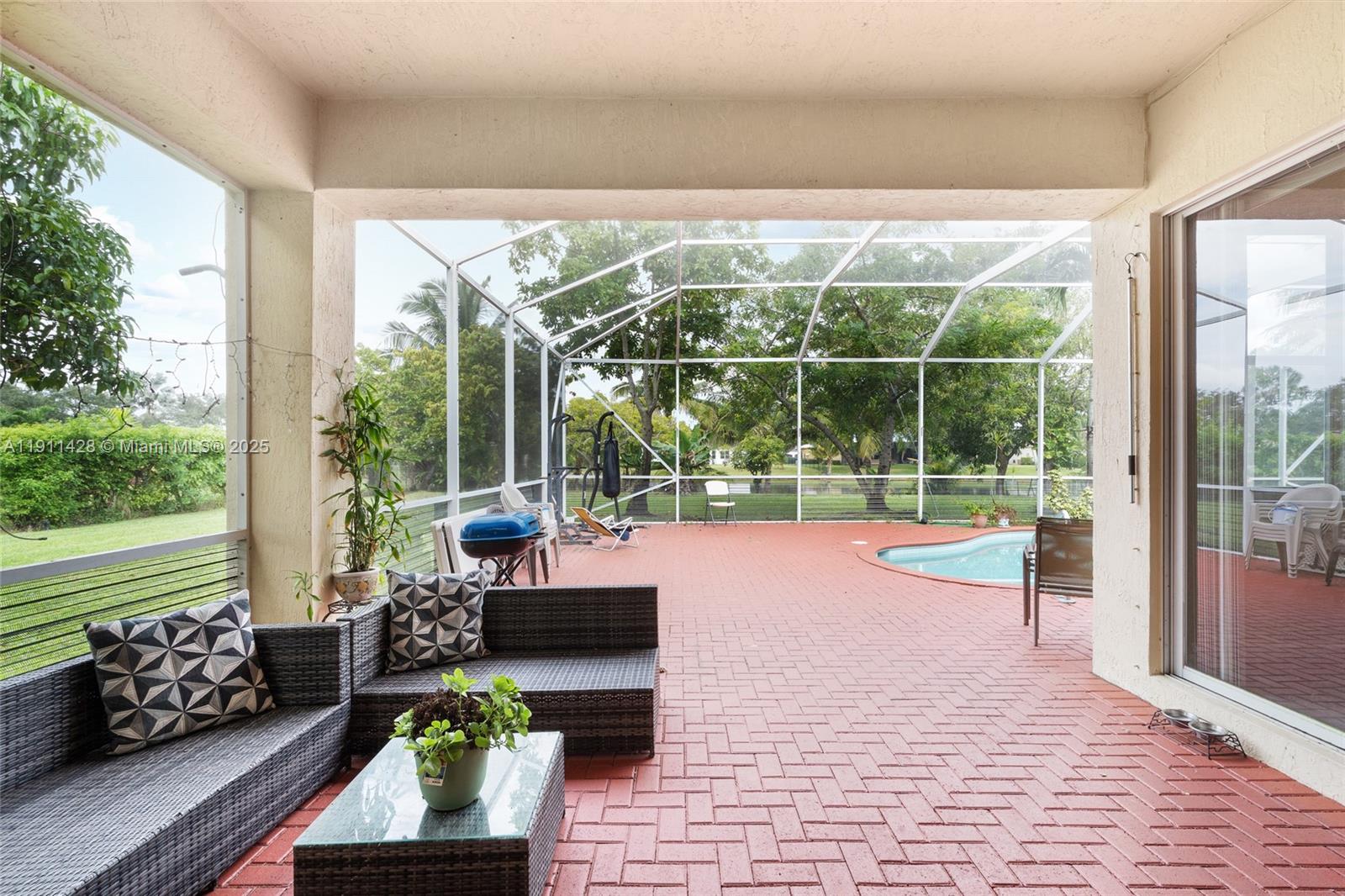 13875 Southwest 41st Street Davie, FL 33330 - Photo 38 of 62 a living room filled with furniture and a large window