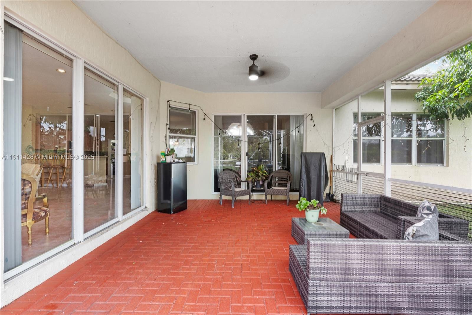 13875 Southwest 41st Street Davie, FL 33330 - Photo 39 of 62 a view of a living room and kitchen with furniture and floor to ceiling window