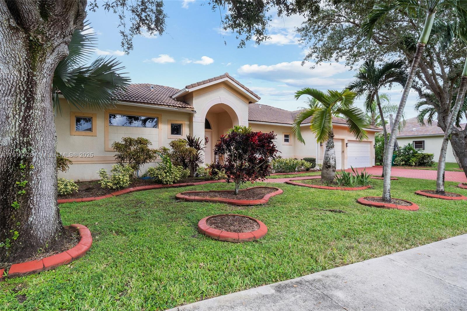 13875 Southwest 41st Street Davie, FL 33330 - Photo 4 of 62 a view of a house with swimming pool and a yard