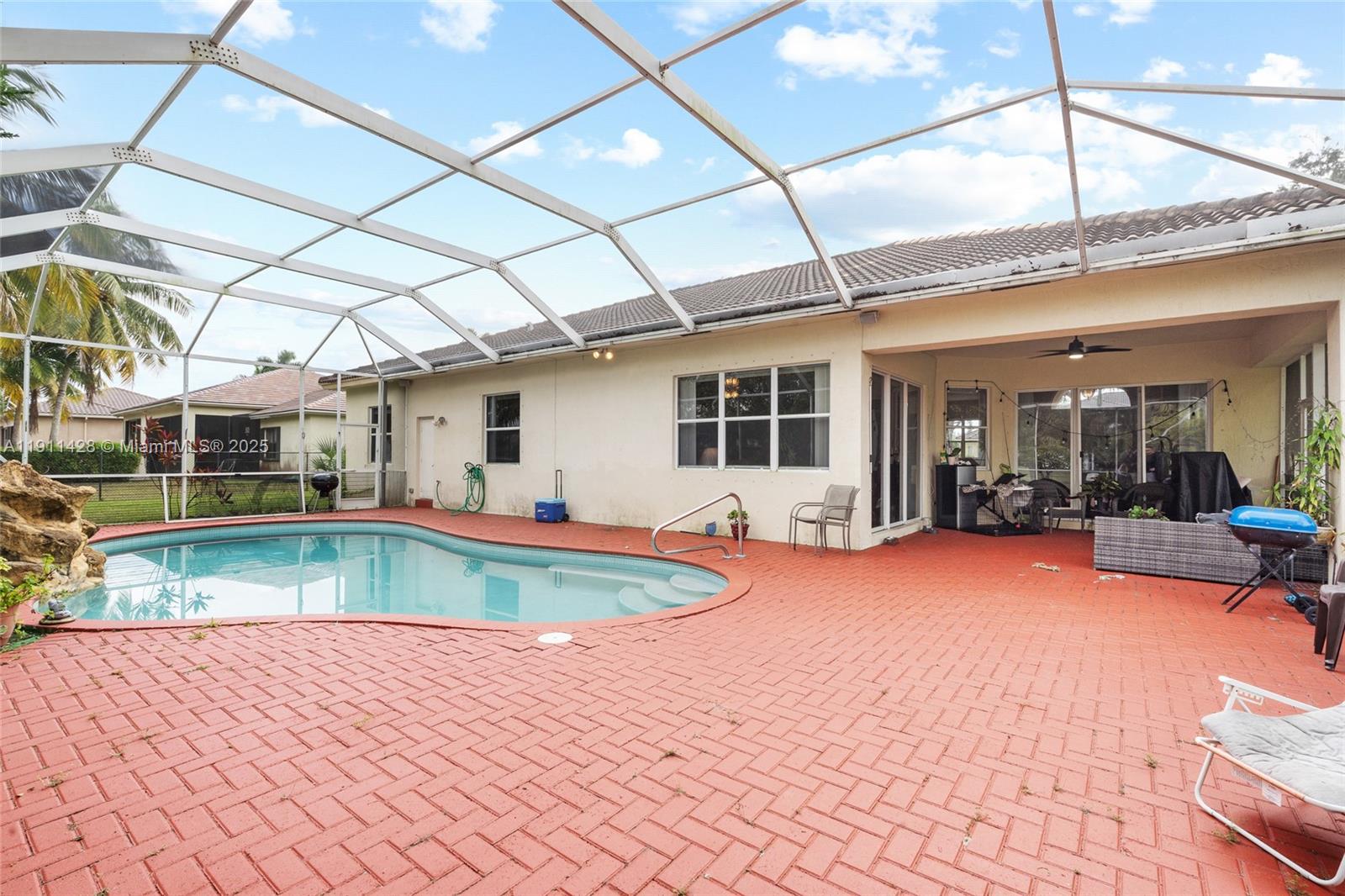 13875 Southwest 41st Street Davie, FL 33330 - Photo 42 of 62 a view of a house with swimming pool and sitting area