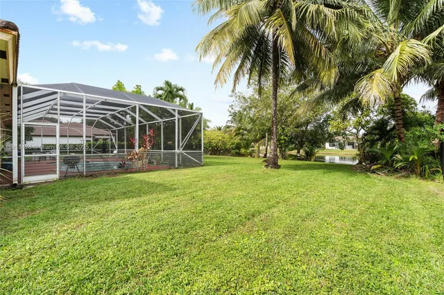 an aerial view of residential house with outdoor space and trees