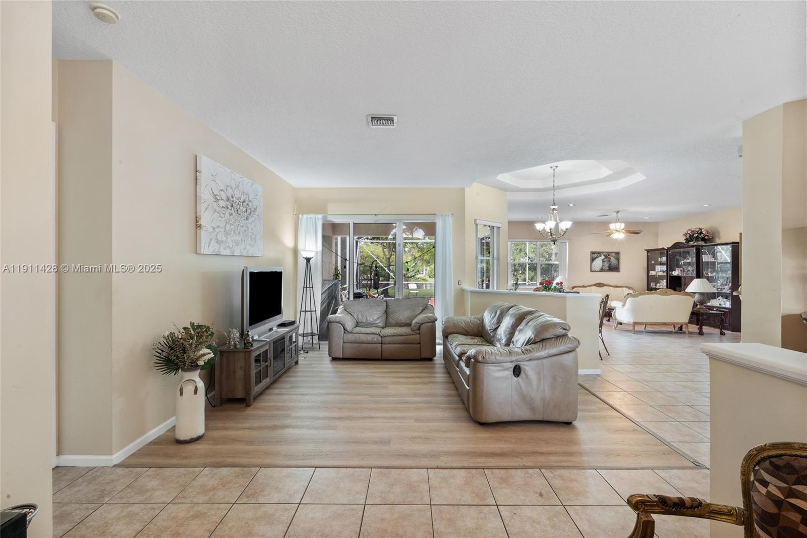 13875 Southwest 41st Street Davie, FL 33330 - Photo 6 of 62 a living room with furniture and a flat screen tv