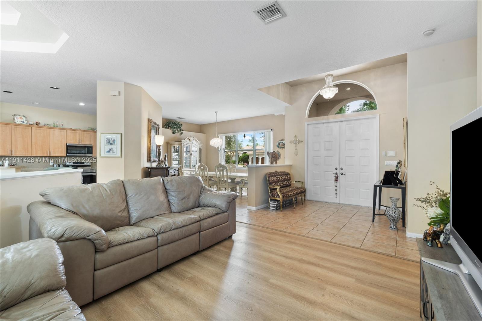 13875 Southwest 41st Street Davie, FL 33330 - Photo 8 of 62 a living room with furniture and a flat screen tv