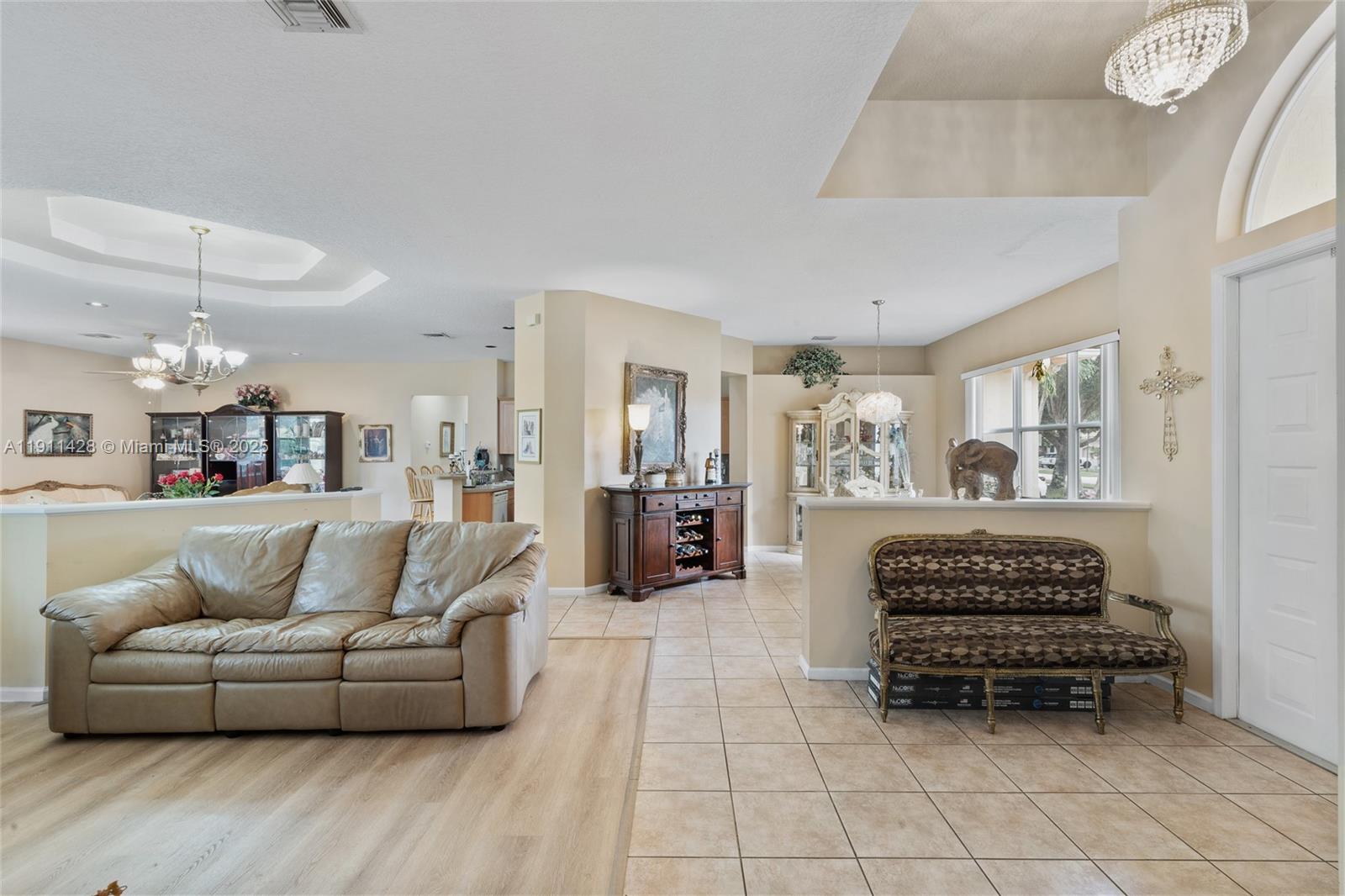 13875 Southwest 41st Street Davie, FL 33330 - Photo 9 of 62 a living room with furniture and a chandelier