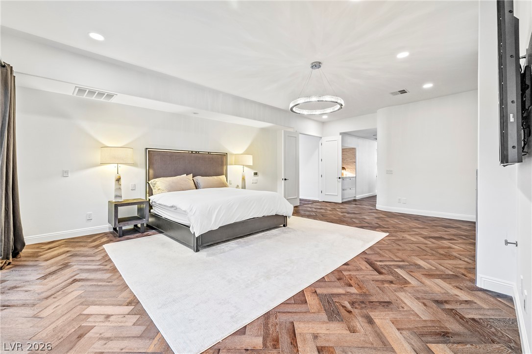 2000 Grouse Street Las Vegas, NV 89134 - Photo 40 of 89 Herringbone hardwood floors add character to this expansive sleeping area with recessed lighting.
