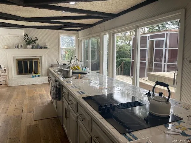 a living room with fireplace furniture and a large window