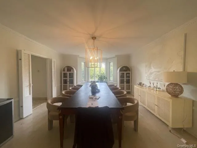 a view of a dining room with furniture and chandelier