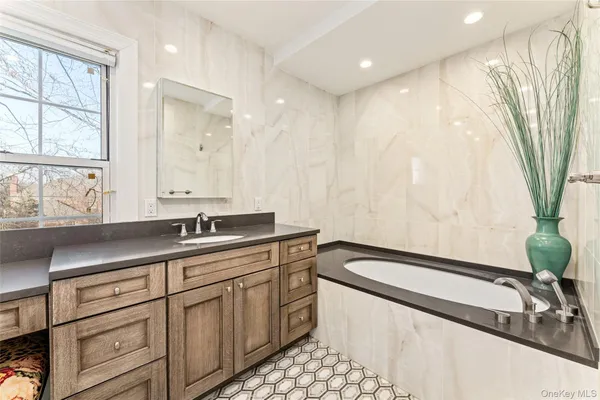 a bathroom with a double vanity sink toilet mirror and shower