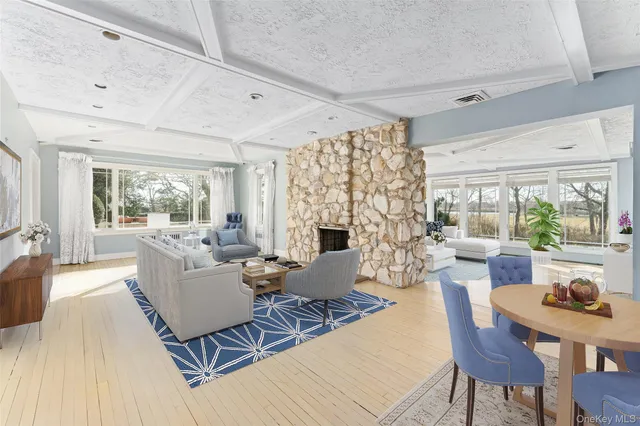 a living room with fireplace furniture and a large window