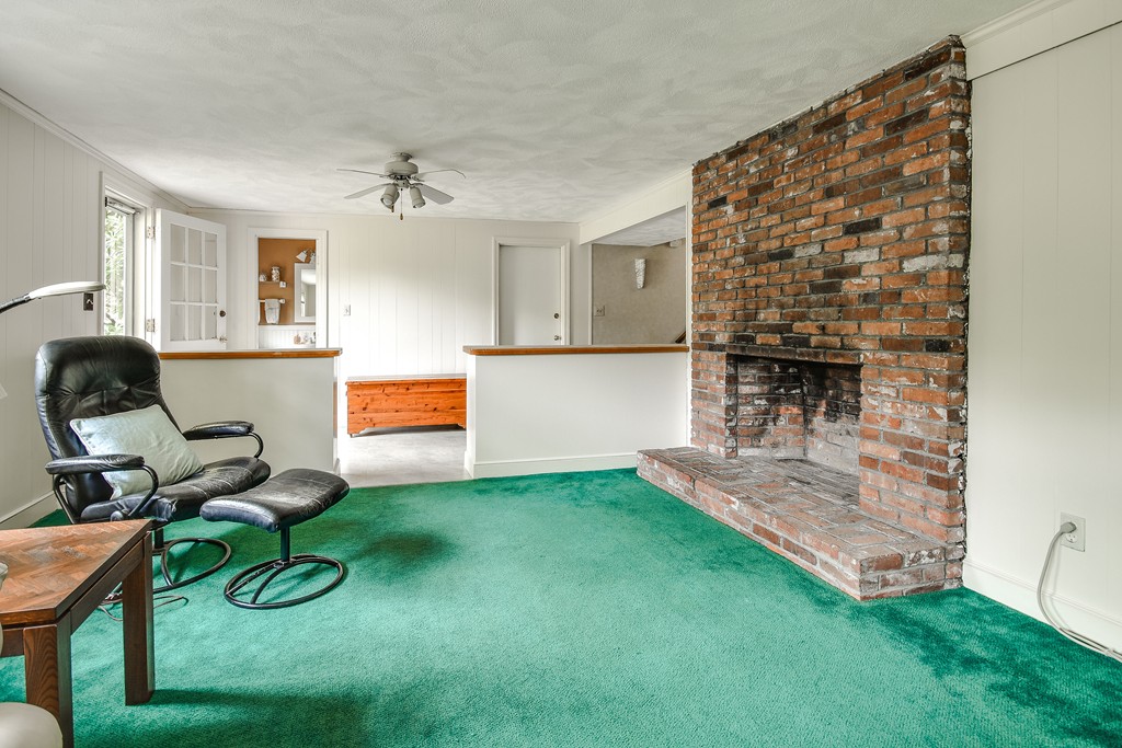 18 Griscom Road Sudbury, MA 01776 - Photo 20 of 29 a living room with furniture and a fireplace