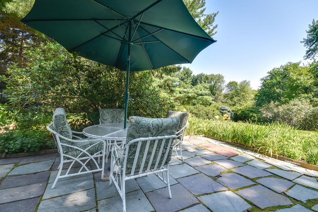 18 Griscom Road Sudbury, MA 01776 - Photo 22 of 29 a patio with a yard table and chairs