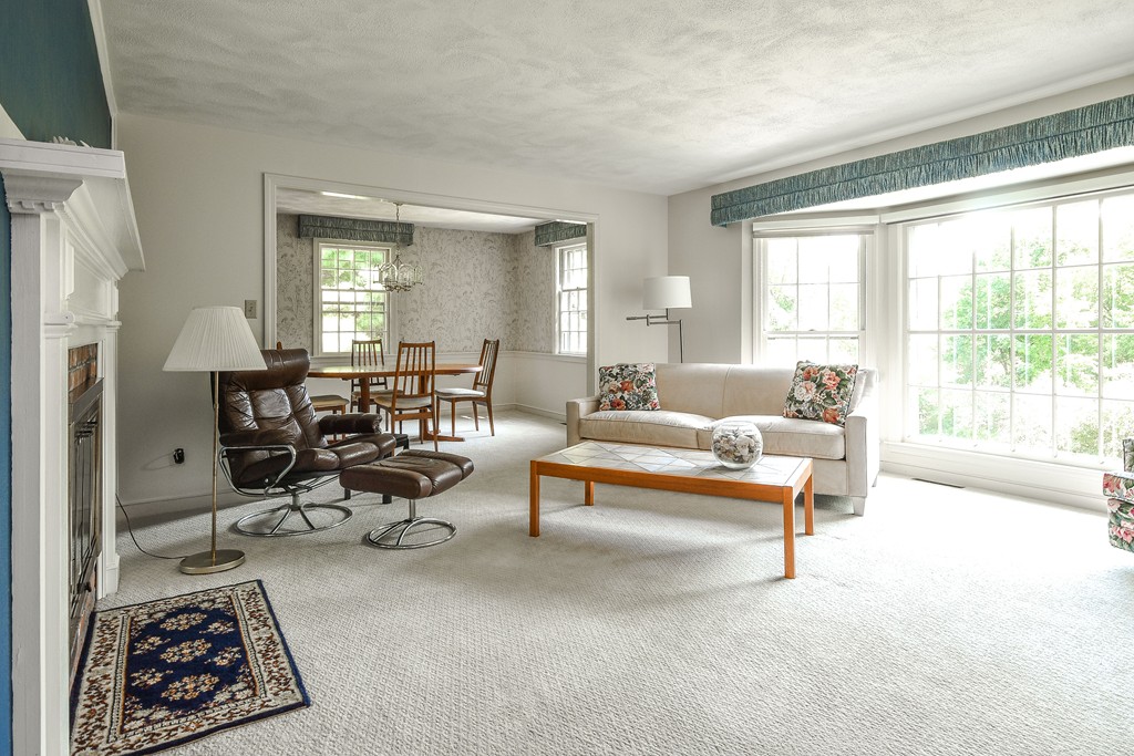 18 Griscom Road Sudbury, MA 01776 - Photo 3 of 29 a living room with furniture a rug and a large window