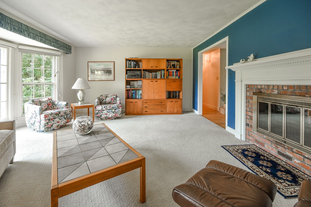 18 Griscom Road Sudbury, MA 01776 - Photo 4 of 29 a bedroom with furniture and a fireplace